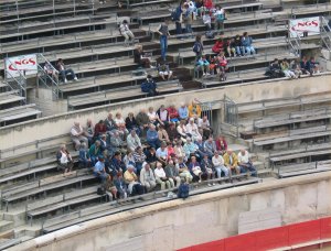 Some pensioners sit attentively while some kids take a more relaxed approach.